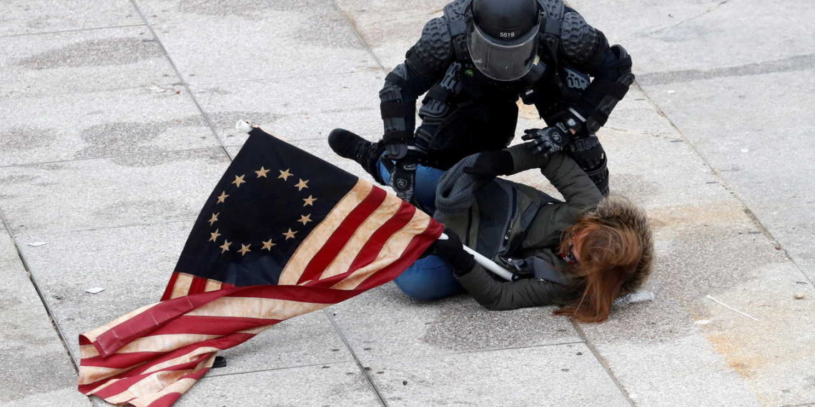 A police officer detains a pro-Trump protester as mobs storm the U.S. Capitol, during a rally to contest the certification of the 2020 U.S. presidential election results by the U.S. Congress, at the U.S. Capitol Building in Washington, U.S, January 6, 2021. REUTERS/Shannon Stapleton     TPX IMAGES OF THE DAY