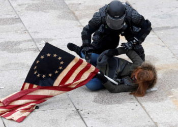 A police officer detains a pro-Trump protester as mobs storm the U.S. Capitol, during a rally to contest the certification of the 2020 U.S. presidential election results by the U.S. Congress, at the U.S. Capitol Building in Washington, U.S, January 6, 2021. REUTERS/Shannon Stapleton     TPX IMAGES OF THE DAY