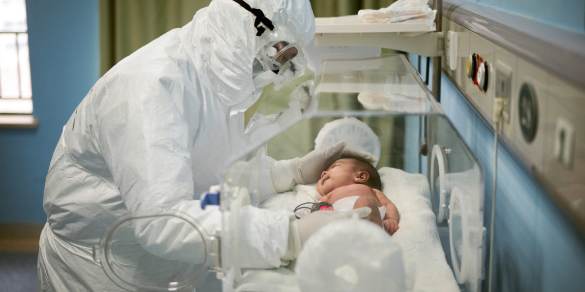 FILE PHOTO: A medical staff attends to a baby with novel coronavirus at the Wuhan Children’s Hospital, in Wuhan, the epicentre of the novel coronavirus outbreak, in Hubei province, China March 6, 2020. China Daily/via REUTERS/File Photo ATTENTION EDITORS - THIS IMAGE WAS PROVIDED BY A THIRD PARTY. CHINA OUT. SEARCH "1ST ANNIVERSARY OF THE WUHAN LOCKDOWN" FOR THE PHOTOS.