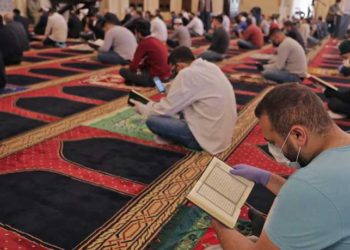 Worshippers gather for the Friday prayers during the Muslim holy month of Ramadan, while keeping a safe distance from each other, at the Mohammed Al-Amin Mosque in the Lebanese capital Beirut's downtown district, after some measures that were taken by the authorities in a bid to prevent the spread of the novel coronavirus were eased, on May 8, 2020. (Photo by ANWAR AMRO / AFP)