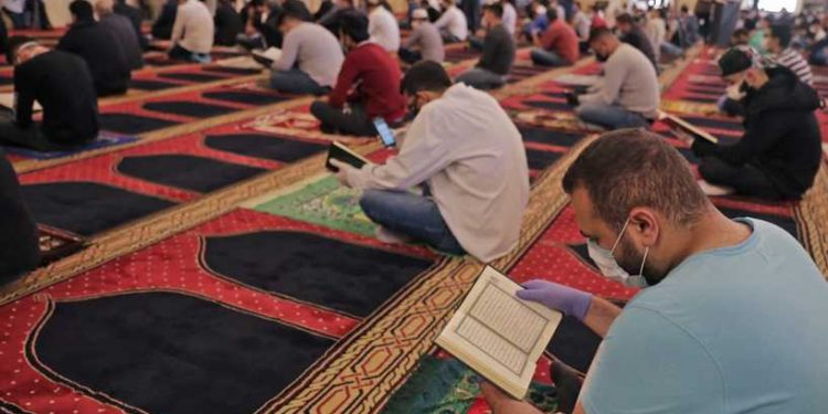 Worshippers gather for the Friday prayers during the Muslim holy month of Ramadan, while keeping a safe distance from each other, at the Mohammed Al-Amin Mosque in the Lebanese capital Beirut's downtown district, after some measures that were taken by the authorities in a bid to prevent the spread of the novel coronavirus were eased, on May 8, 2020. (Photo by ANWAR AMRO / AFP)