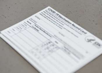 A Covid-19 vaccine record card is seen at Florida Memorial University Vaccination Site in Miami Gardens, Florida on April 14, 2021. - Florida Division of Emergency Management has opened a new permanent vaccination site at Florida Memorial University. The walk-up site will administer 200 doses of Moderna vaccine per day to any Florida resident over the age of 18. (Photo by CHANDAN KHANNA / AFP)