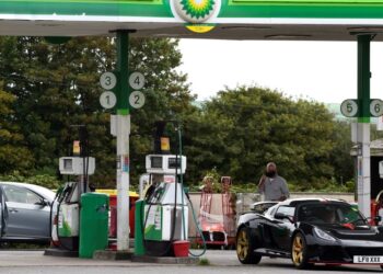 Cars wait at a BP petrol and diesel filling station, Llanteg, Pembrokeshire, Wales, Britain, September 24, 2021. REUTERS/Rebecca Naden