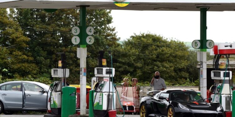 Cars wait at a BP petrol and diesel filling station, Llanteg, Pembrokeshire, Wales, Britain, September 24, 2021. REUTERS/Rebecca Naden