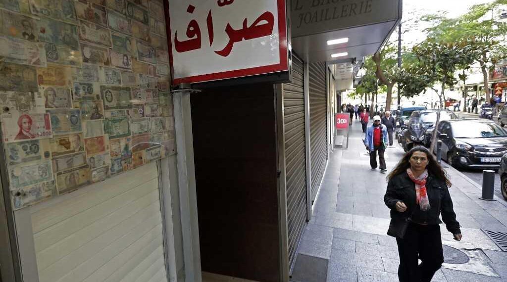 A client stands in front of a closed money exchange office in Beirut on November 29, 2019. (Photo by JOSEPH EID / AFP)