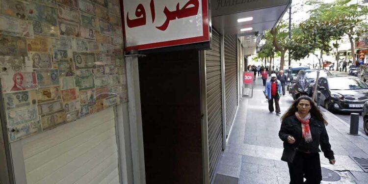A client stands in front of a closed money exchange office in Beirut on November 29, 2019. (Photo by JOSEPH EID / AFP)