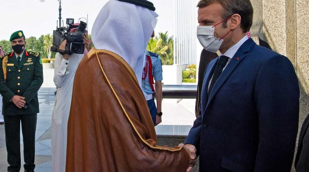 French President Emmanuel Macron (R) is received by Saudi Crown Prince Mohammed bin Salman (L) in Saudi Arabia's Red Sea coastal city of Jeddah on December 4, 2021. (Photo by AFP)