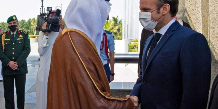 French President Emmanuel Macron (R) is received by Saudi Crown Prince Mohammed bin Salman (L) in Saudi Arabia's Red Sea coastal city of Jeddah on December 4, 2021. (Photo by AFP)