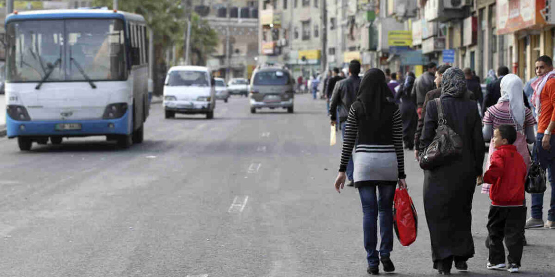 People walk on a street during a general strike by public transport workers in central Amman November 14, 2012. Protests erupted in Jordan's capital Amman and provincial towns after the government cut fuel subsidies in a move to secure a $2-billion IMF loan but which sent fuel prices soaring. REUTERS/Muhammad Hamed (JORDAN - Tags: POLITICS CIVIL UNREST ENERGY TRANSPORT BUSINESS EMPLOYMENT)