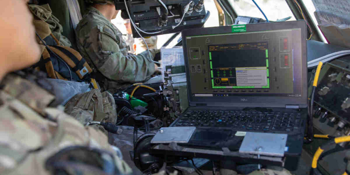 U.S. Soldiers assigned to 2nd Battalion, 20th Field Artillery Regiment, work with the Autonomous Multi-Domain Launcher (AML), on a Palletized Load System (PLS) using a Remote Interface Unit (RIU) as a part of Project Convergence 22 at Fort Irwin, California, Oct. 31, 2022. Project Convergence 22 experimentation incorporates technologies and concepts from all services and from multinational partners, including in the areas of autonomy, augmented reality, tactical communications, advanced manufacturing, unmanned aerial systems and long-range fires. (U.S. Army photo by SPC Collin S. MacKown)