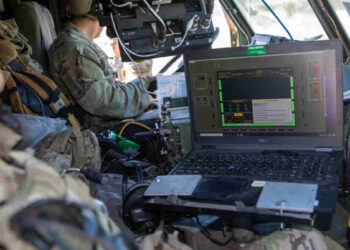 U.S. Soldiers assigned to 2nd Battalion, 20th Field Artillery Regiment, work with the Autonomous Multi-Domain Launcher (AML), on a Palletized Load System (PLS) using a Remote Interface Unit (RIU) as a part of Project Convergence 22 at Fort Irwin, California, Oct. 31, 2022. Project Convergence 22 experimentation incorporates technologies and concepts from all services and from multinational partners, including in the areas of autonomy, augmented reality, tactical communications, advanced manufacturing, unmanned aerial systems and long-range fires. (U.S. Army photo by SPC Collin S. MacKown)