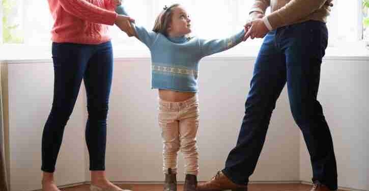 Two Parents Fighting Over Child In Divorce Concept
