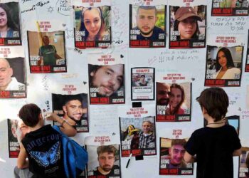 Messages are left on a wall showing the portraits of Israeli hostages held by Palestinian Hamas gunmen since the October 7 attack into Israel, during a rally calling for their release in the Israeli coastal city of Tel Aviv, on October 28, 2023, amid the ongoing battles between Israel and the Palestinian group Hamas. - The families of th more than 220 hostages Israeli hostages held by Hamas demanded on October 28, for an immediate government explanation about their fate after the army's intensified strikes. The Hostages and Missing Families Forum, which represents some 229 people believed abducted by Hamas, said the war cabinet had failed to explain to relatives whether the ground operation endangered the captives' well-being. (Photo by JACK GUEZ / AFP)