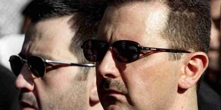 (FILES) In this file photo taken on June 13, 2000, the sons of Syria's late President Hafez al-Assad, Maher (L) and Bashar (R), march behind their father's coffin during his funeral in Damascus. - Bashar al-Assad's rise to power after three decades of his father's iron-fisted rule raised hope of democratic opening. But 20 years later, Syria is isolated and war-ravaged. (Photo by RAMZI HAIDAR / AFP)