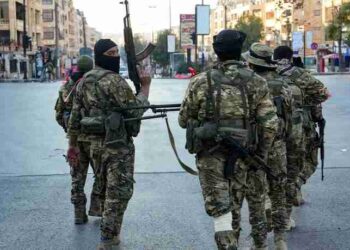 Anti-government fighters patrol in central Aleppo on November 30, 2024. Jihadists and their Turkish-backed allies breached Syria's second city of Aleppo on November 29, as they pressed a lightning offensive against forces of the Iranian- and Russian-backed government. (Photo by Muhammad HAJ KADOUR / AFP)