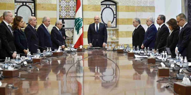 epa11887965 Lebanese President Joseph Aoun (C), Lebanese Prime Minister Nawaf Salam (C-L) and ministers observe a minute of silence for the victims of the Israel-Hezbollah conflict before the first meeting of the new Lebanese cabinet, at the presidential palace in Baabda, east of Beirut, Lebanon, 11 February 2025. Salam, former president of the International Court of Justice (ICJ), was designated as Lebanon's Prime Minister by President Joseph Aoun, after gaining the support of the majority of lawmakers during the president's parliamentary consultation, ending more than two years under a caretaker cabinet.  EPA/WAEL HAMZEH